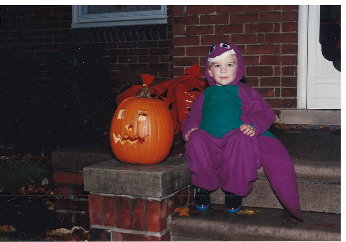 Eric Nietering proudly poses in the Barney costume made by his mother Emily.